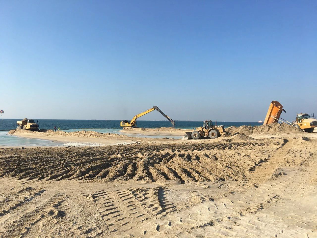 Excavator and earthmoving plant on Al Wasl Island Beach.