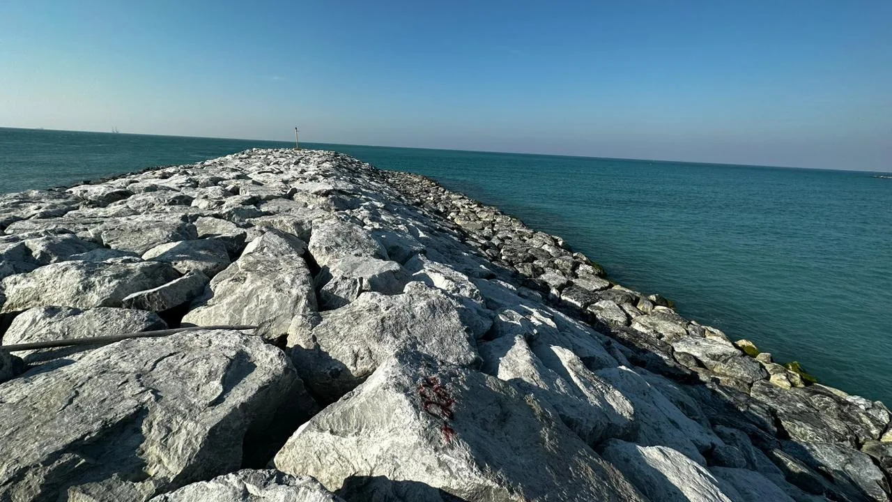 Rock breakwater extending into the sea at the Guggenheim Museum project.